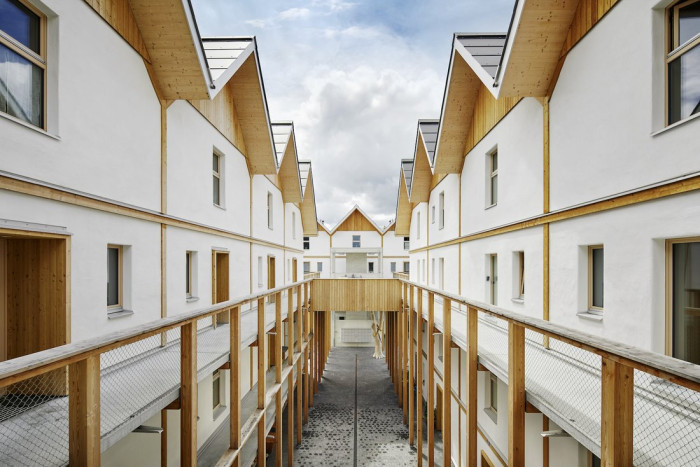 Atelier Schmidt: bytové domy Bombasei ve švýcarském Nänikonu (2020); čtyřpodlažní prefabrikovaná dřevěná konstrukce s výplní ze slaměných balíků