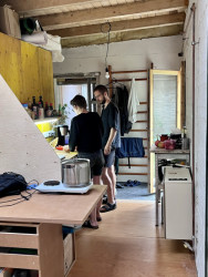 Kuchyňka. Autoři zrovna připravují čerstvý salát i s vlastními rajčaty