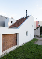 Původně slepá stěna dostala tři malá okna a průřez do dvorku, který je jinak celý obehnaný stěnami. (Rodinný dům v Kohoutovicích, Ateliér Kopecký)