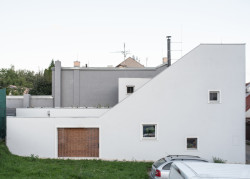 Původně slepá stěna dostala tři malá okna a průřez do dvorku, který je jinak celý obehnaný stěnami. (Rodinný dům v Kohoutovicích, Ateliér Kopecký)