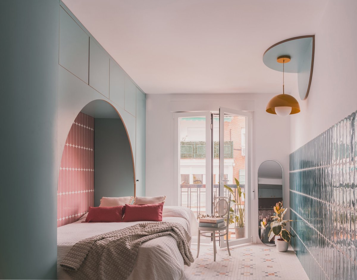 Hlavní obytný prostor tvoří obývací pokoj s jídelním stolem, gaučem a postelí. Je tu také okno, ústící na balkon. (TUR House, OOIIO)