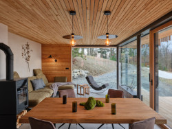 Skleněné stěny v obývacím pokoji nic nezakrývá - odtud se těží z ničím nerušených výhledů. (Chata Kohútka od SENAA architekti)