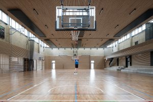 Vnitřní sportoviště je navrženo jako jeden veliký prostor, který lze předělit sítěmi na tři menší tělocvičny. (Hala Řevnice, Grido)