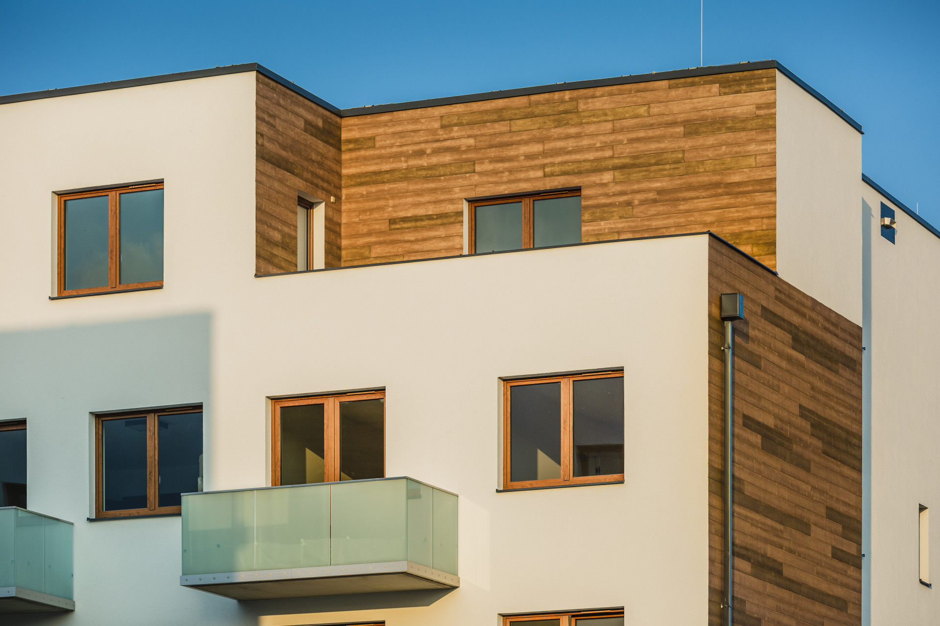 Dřevěný dekor může dotvářet celkový dojem fasády větších i menších projektů. Na bytovém domě v Olomouci byly použity v kombinaci s omítkou StoSignature imitující beton a bílou fasádní omítkou StoSilco