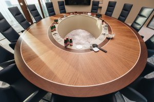 V zasedací místnosti stojí velký elipsovitý stůl s intarzovanou deskou. (Kancelářské prostory v Bratislavě; Zuzana Basandová z ateliéru ZURI Architecture)