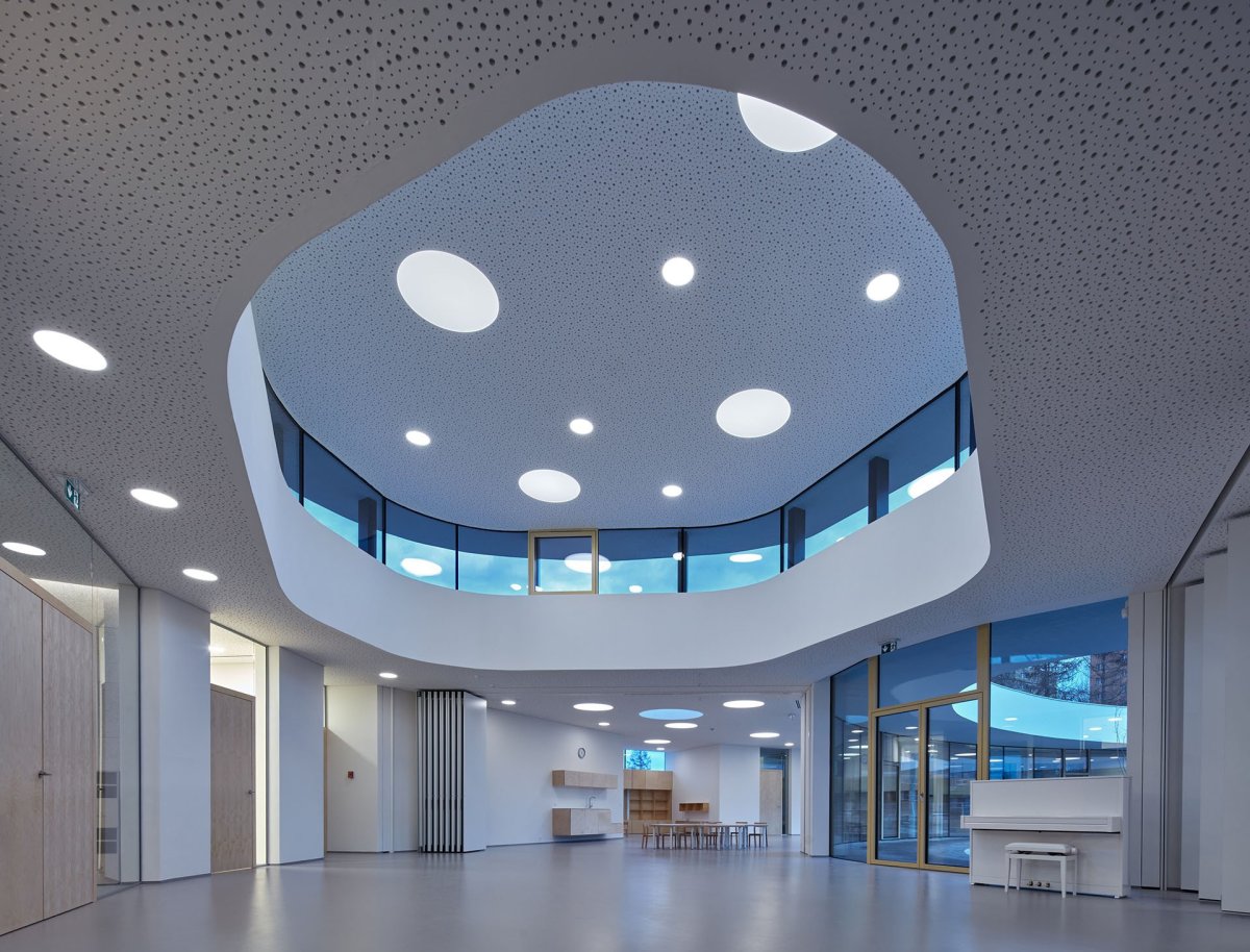 Vnitřní tvarování a barevnost podhledů působí jako vesmírná loď. (Školka Varnsdorf, RG architects studio)