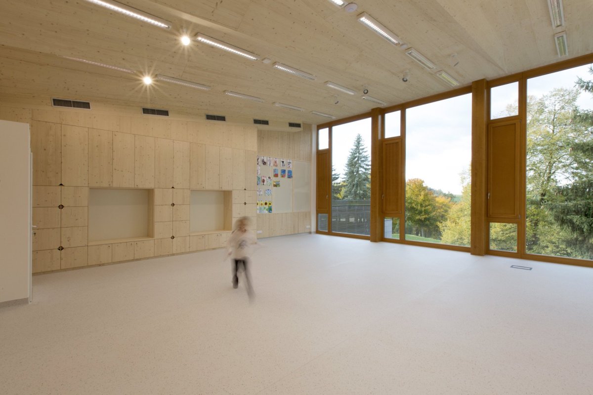 Přístavba školy ve Studenci, CHRAMA: Čistým interiérům dominuje ve společných prostorách pohledový beton, v prostorách tříd naopak světlé odstíny dřevěného obložení