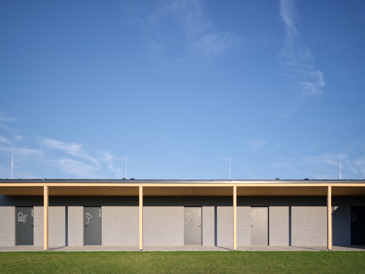 Čtyři samostatné objekty vizuálně i provozně propojuje dřevěné loubí. (Sportovní areál SK Planá, PROAM ARCHITEKTI)