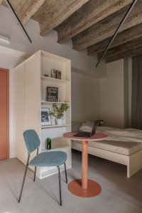Odkrytý žebříkový strop je organickým prvkem interiéru. (Metropol Be One Apartments v Bratislavě od BEEF ARCHITEKTI)