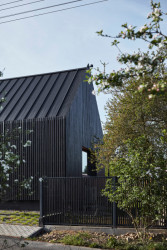 Do ulice se dům obrací černou fasádou. (Dům ve Vraném nad Vltavou, 0,5 Studio)