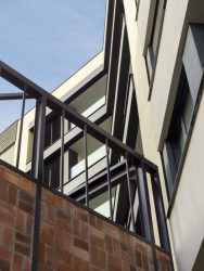 Kovové prvku zůstaly v areálu i jako zábradlí (Rezidenční bydlení vzniklo z holešovického brownfieldu; A69 architekti)