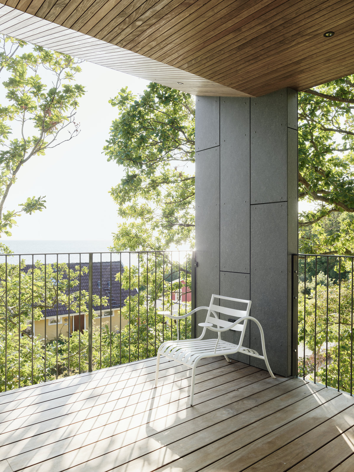 Dům na pobřeží Švédska splývá s okolní vegetací. Je za tím i fasáda z šedivého vláknocementu Swisspearl. 