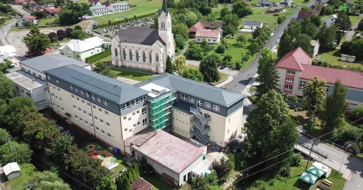 Nástavba základní školy Vidče vyřešila nedostatek prostor pro výuku. Pracuje s kontrastem mezi tmavou současnou vrstvou a původní světlou fasádou z 80. let.