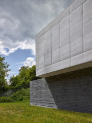 Detail prkenného bednění na tmavé betonové podnoži a světlé hladké patro (Vila Troja, Stempel & Tesar architekti)