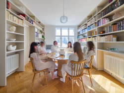 Společný život se odehrává v největším z pokojů. Je tu knihovna, jídelna ... (Rekonstrukce bytu v Praze, No Architects)