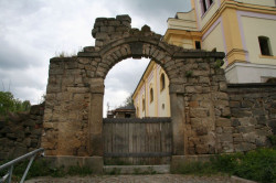 Stav brány v ohradní zdi před rekonstrukcí (2012). Chybějící část brány a její celkový tvar byly odvozeny z historických fotografií - foto