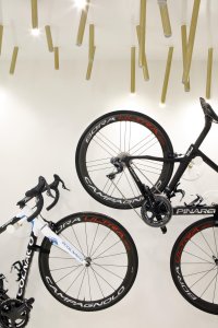 Cyklobutik L27, P6PA+Architects: Lesklý povrch stěn zrcadlí osvětlení v místnosti i kola zavěšená na zdech