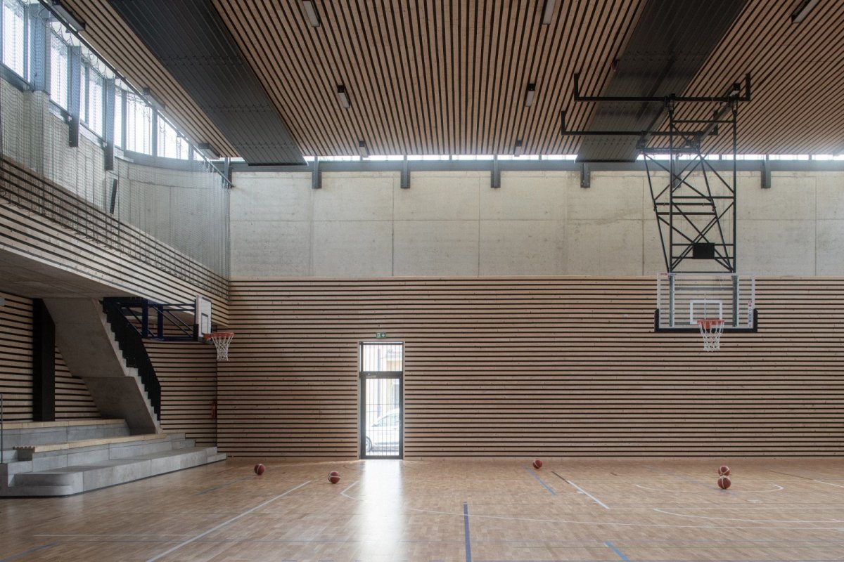 Vnitřní sportoviště je navrženo jako jeden veliký prostor, který lze předělit sítěmi na tři menší tělocvičny. (Hala Řevnice, Grido)