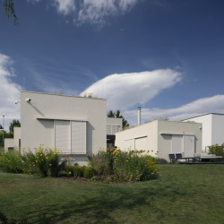 Vstup a garáž jsou v úrovni ulice, zbytek domu o patro níž. (A69 architekti, rodinný dům ve Slivenci)