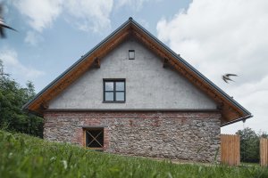 Zůstala ale i konstrukce široké sedlové střechy z 90. let, k domu se totiž hodí. (Rekonstrukce rodinného domu na Šumavě, Archport)