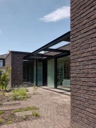 Z obývacího pokoje se dá vystoupit ven do poloatria a pak dál do zahrady. (Rodinný dům v Řepích, Stempel & Tesař architekti)