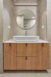 Pro koupelnu zvolili autoři jemné béžové terazzo. Ložnice navazuje na materiály zvolené pro obývací část - dubové dřevo v kombinaci se šedobéžovou. (Rekonstrukce bytu ve Strašnicích, MENU architekti)