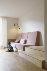 Pohled do obývacího pokoje se zabudovanou sedací soupravou (Bydlení v řadovém domě v Praze-Strašnicích, BY architects)