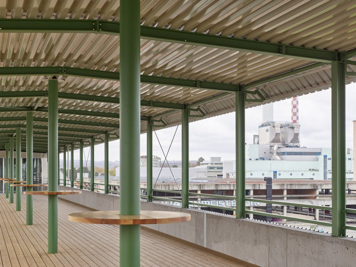 Sdílená terasa  s výhledem na průmyslový okrsek Lysbüchel (Konverze skladu vína na komunitní bydlení; Esch Sintzel Architekten)
