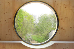 Kulaté okno s nízkým parapetem funguje jako příjemné posezení. 