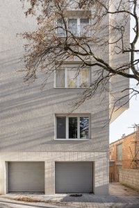 Rekonstrukce bytu a bytového domu Nový Svet, ARCHITEKTI mikulaj & mikulajová - Strukturovaná břízolitová omítka a světlý keramický obklad kabřince odkazují na charakter původních architektonických prvků